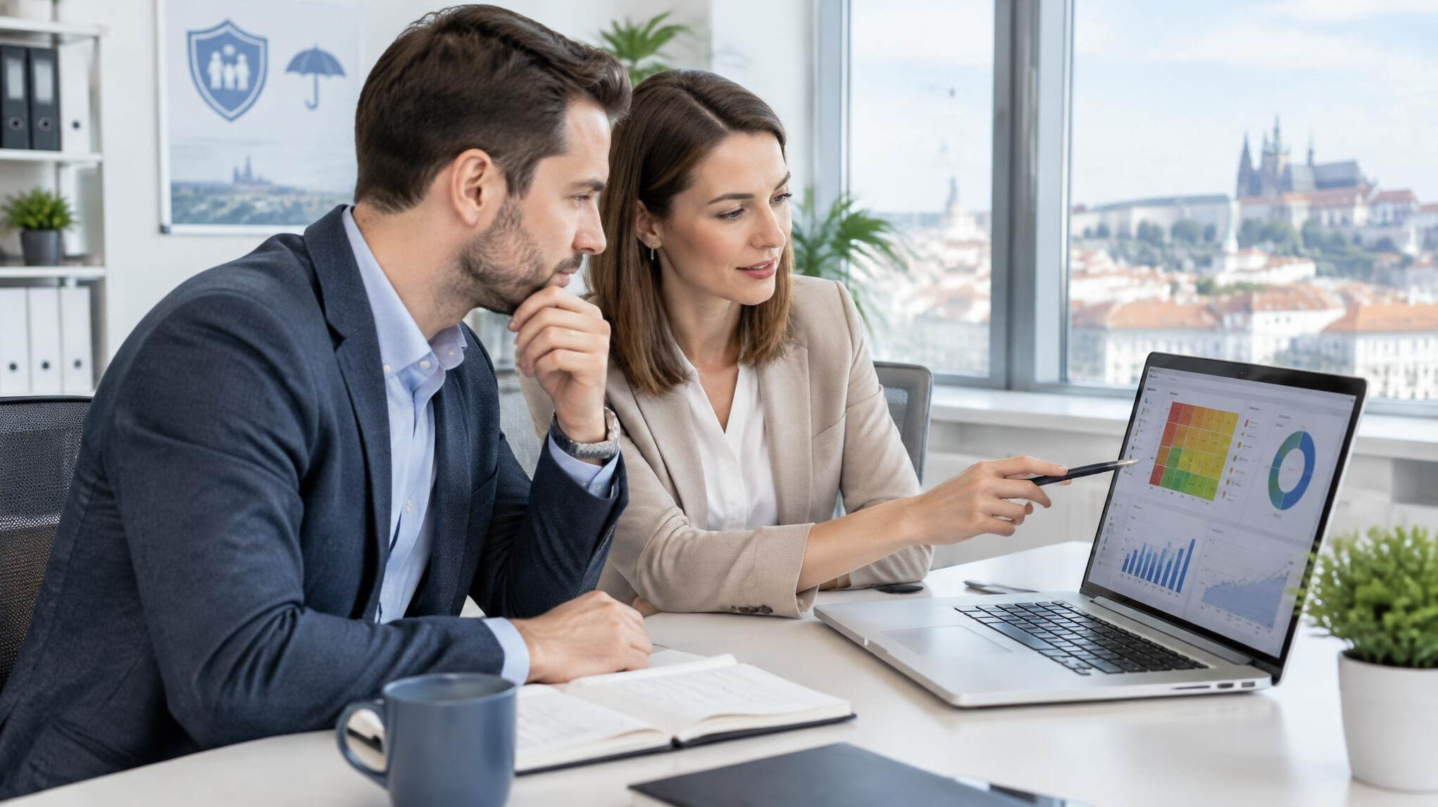 Team reviewing insurance data on a laptop in a modern office