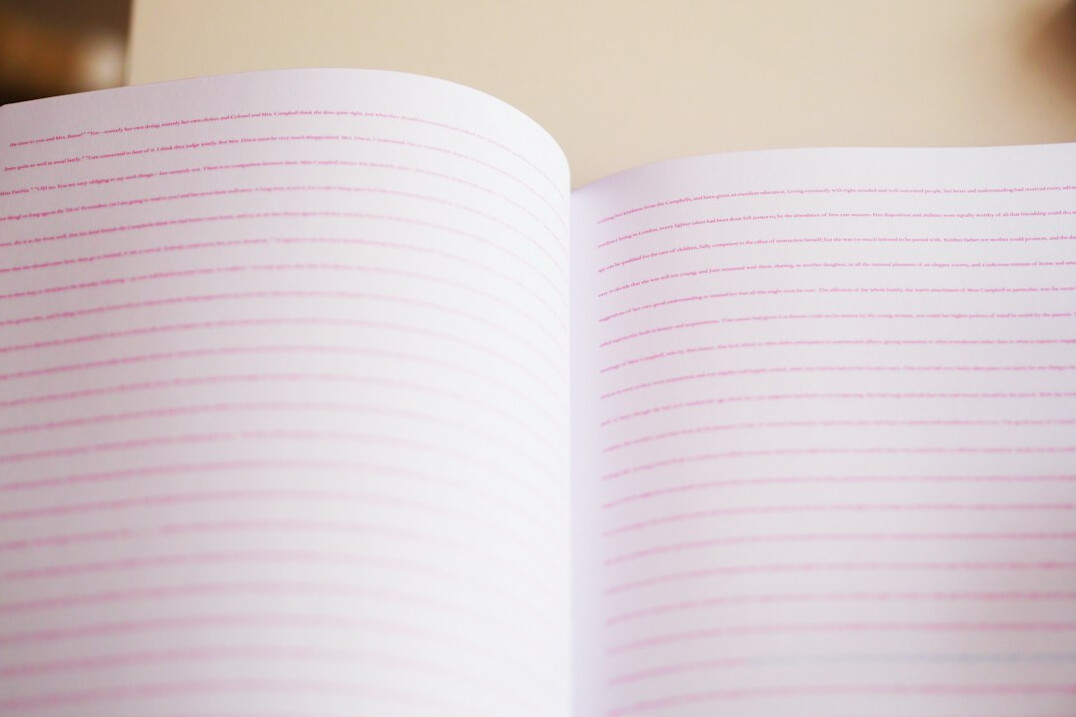 Close-up of a hand writing notes in a notebook